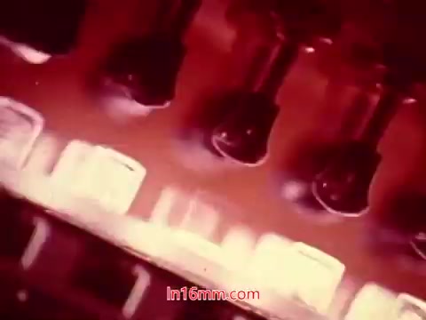 The still from the 16mm film 'Performance' is likely to feature a vibrant, abstract composition, possibly showcasing mechanical elements with an emphasis on color and texture. The film’s end titles display production details, including the date and credits for the cast and crew. The visual elements may be representative of the era's aesthetic, combining artistic techniques with an industrial theme typical of Bell System productions.