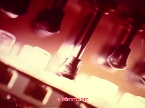 The still from the 16mm film 'Performance' features a close-up shot, likely showcasing intricate details of equipment or gadgets relevant to the film's theme. The colors are vivid, with a warm tone dominating the image, suggesting a focus on mechanical or technical elements. This particular frame captures the essence of the film's ending, highlighting key production information like the date and credits for the cast and crew involved. The visual style aligns with the artistic approach of early 1970s cinema, emphasizing both aesthetics and information.