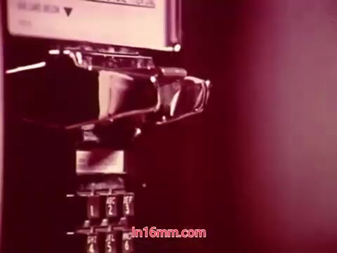 The still from the 1971 film 'Performance' shows a close-up of a vintage payphone. The focus is on the receiver and keypad, with a slight pinkish tint, characteristic of the film's aesthetic. This scene likely serves as a transitional moment in the film, culminating in the end titles, which provide details of the production date and list the cast and crew involved. The overall impression evokes a sense of nostalgia, reflecting the technology and cultural context of that era.