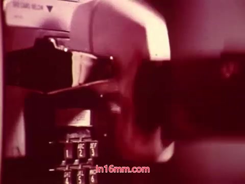 The still from 'Performance' shows a close-up of a vintage phone being dialed, capturing a sense of retro technology. The color tones are warm, giving a nostalgic feel. The end titles overlay the visual, providing details about the production date and listing the cast and crew involved. This moment encapsulates the film's finality, highlighting its historical context and creative contributions.