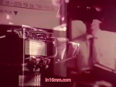 The still from 'Performance' (1971) features a collage of images typical of 16mm prints, highlighting the film's end titles. It includes onscreen text with production details, cast, and crew credits. The visual aesthetic shows a blend of graphic elements, possibly showcasing a mix of technology and human presence, common in promotional films of that era. The image has a vintage quality, reflecting the film's release period and its unique style.