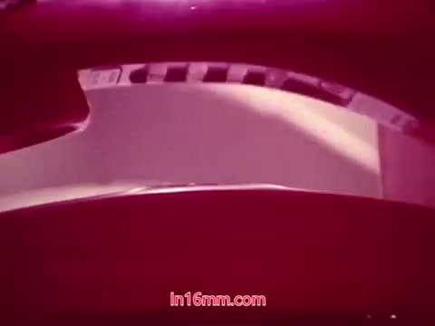 The still from 'Performance' - a Bell System Film from 1971 - shows a close-up of a film reel. The vibrant colors and texture suggest the aged quality of 16mm film. It likely features the end titles with production details, including the date and credits for cast and crew involved in the film. The image captures the nostalgic essence of film history, emphasizing the physicality of film media.