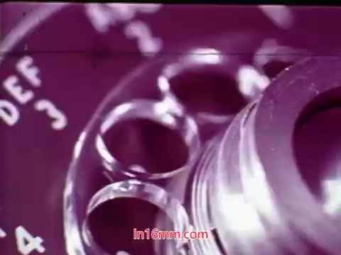 The 16mm still from 'Performance' - a Bell System Film from 1971 - features a close-up of a film reel, focusing on the mechanical details. The intricate structure of the reel, including lens elements and dials, is prominently displayed, likely emphasizing the technical craftsmanship involved in filmmaking. The end titles indicate the film's production date and list the cast and crew, providing context and acknowledgement for their contributions. The print's quality and visual details reflect its vintage nature.