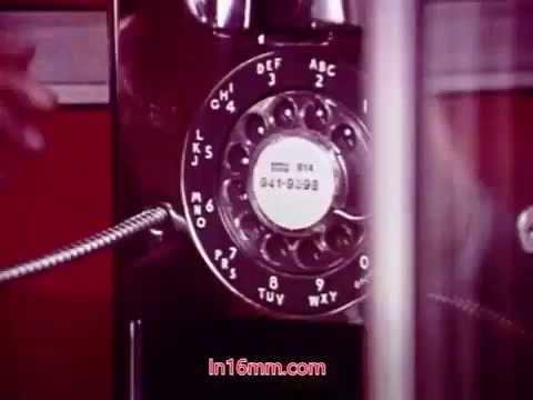 The still features a close-up of a rotary telephone, highlighting its circular dial with numbers and letters. The phone's design reflects the technology of the early 1970s, suggesting a retro aesthetic. The background appears blurred, emphasizing the phone itself. This scene likely serves as a visual element in the broader context of 'Performance,' echoing themes related to communication or connection. The end titles note the production date and list the cast and crew involved in the film.