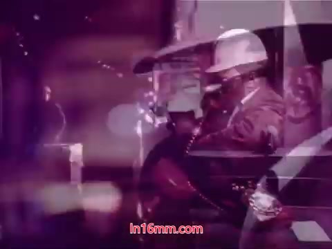 The still from 'Performance' shows a vibrant, abstract montage with a strong emphasis on color and light. The imagery appears layered and overexposed, creating a dreamlike quality. A figure in a hard hat is featured prominently, suggesting a scene related to industry or authority. The overall composition conveys a sense of movement and narrative, typical of the film's experimental style. This particular still includes end titles, denoting production details, cast, and crew, marking the conclusion of the film.