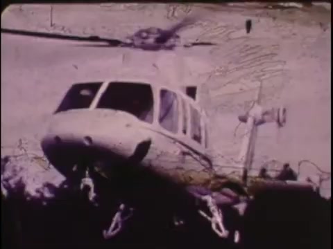 The still from the Sikorsky S-76 promo film (1977) depicts a helicopter in motion, likely showcasing its design and capabilities. The image appears faded and shows signs of wear typical of a 16mm workprint. The Sikorsky S-76’s distinctive shape is evident, emphasizing its role in the aviation sector. The overall tone and quality evoke a nostalgic feel, fitting the era of its production, but lack the clarity of modern visuals. The absence of narration leaves the viewer to interpret the visuals without context.