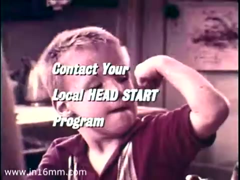 The still from the 1968 PSA 'Head Start' features a young boy flexing his arm and showing off his muscles, symbolizing strength and confidence. The text overlay encourages viewers to 'Contact Your Local HEAD START Program,' emphasizing the initiative's focus on empowering children. The background is soft and colorful, typical of educational films from that era. The image captures the spirit of optimism and support for early education, with Lady Bird Johnson as a notable advocate for such programs.
