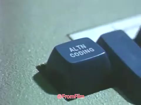 The still features a close-up of a keyboard key labeled 'ALTN CODING,' likely from an early computing terminal, highlighting the technology used during the late 1960s. This imagery reflects the era's burgeoning interest in computing and the role it played in education, exemplifying Point Park College's commitment to modern advancements during that time. The overall presentation signifies a blend of innovation and academic development at Point Park University.