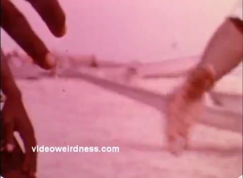 The still shows close-up shots of hands reaching out, likely conveying themes of connection and collaboration. The soft, muted colors suggest a nostalgic or warm tone, appropriate for promoting the Peace Corps' mission of service and community engagement during the 1970s. The focus on hands emphasizes human interaction and solidarity, common themes in public service announcements.