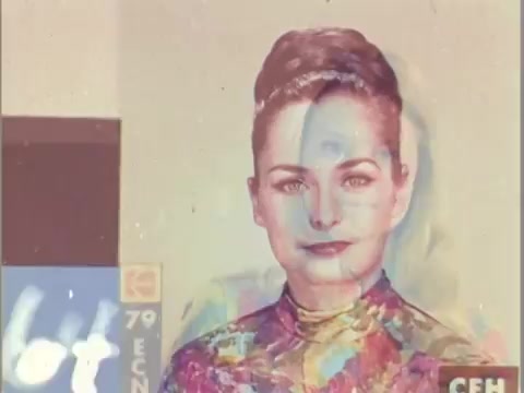 The still features a colorful image of a young woman, often referred to as a 'China girl,' which was commonly used in 16mm film leaders. The vibrant colors and patterns are designed to help film labs assess color accuracy during processing. The image displays an almost ethereal quality, with a blend of hues accentuating the subject's features against a minimal background. This serves both an aesthetic and technical purpose in the context of film production.