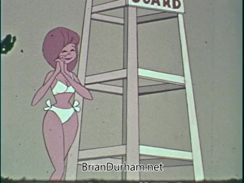 The still from the PSA features a cartoon character of a lifeguard in a white swimsuit, standing happily next to a lifeguard tower. The tower prominently displays the word 'GUARD,' suggesting a focus on swimming safety. The overall tone is light-hearted and promotes a healthy, active lifestyle.