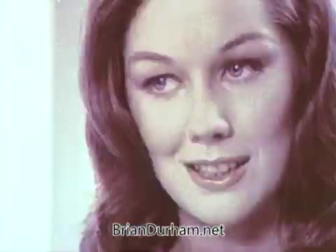 The still features a woman with long, wavy hair and a warm smile, conveying a friendly and inviting demeanor. The soft color palette suggests a vintage aesthetic typical of the late 1960s. The focus appears to be on her expression, likely promoting the benefits of Ivory soap.