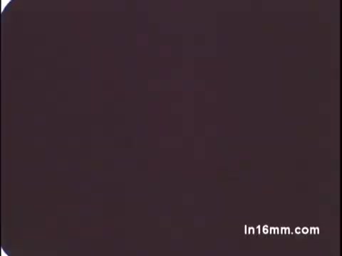 The still from the 1970s venereal disease PSA features a simple, muted background with an emphasis on the topic's serious nature. The visual style is typical of the period, likely aiming to convey an educational or cautionary message about the importance of sexual health and awareness. The graininess and color palette reflect the 16mm film medium of the time.