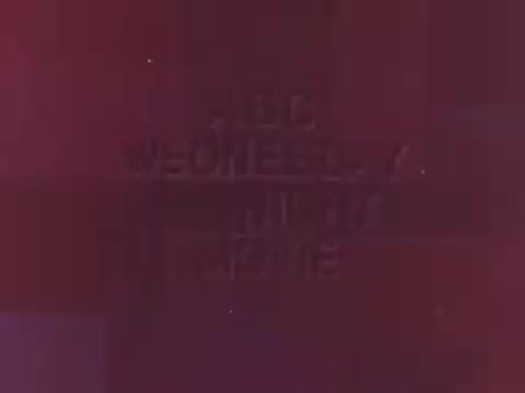 The still features a retro-style graphic featuring the text 'ABC WEDNESDAY NIGHT MOVIE' prominently displayed. The colors appear warm and subdued, characteristic of the late 1960s to early 1970s television aesthetics. It has a nostalgic charm, highlighting the era's unique design and presentation style. The context suggests it was part of a promotional segment related to the Green Goddess Salad Dressing, adding to its appeal for collectors and fans of vintage television.