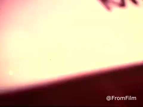 The still from the 1970s Colgate Toothpaste commercial features a blurred image with subtle colors, indicative of a 16mm print. The focus appears to be on the product, hinting at its MFP fluoride formulation. The commercial likely aimed to promote dental health and freshness, typical of advertising from that era. The overall visual has a nostalgic quality, capturing the essence of vintage advertising.