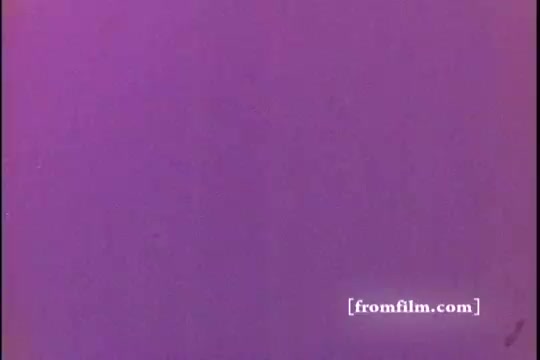 The still features a solid, vibrant purple background, characteristic of older film prints. It lacks distinct imagery or text, suggesting it may be a transition or filler frame from the 'Schick Super II' commercial from the 1970s. The texture and color reflect the unique qualities of 16mm film stock.