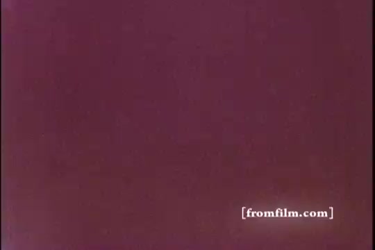 The still from 'Bold Detergent' features a soft, muted color palette with a dominant purple hue. The image appears to be a close-up or abstract shot, possibly highlighting the texture or packaging of the detergent. It captures the vintage aesthetic typical of 1970s advertisements, emphasizing a playful and inviting branding approach. No specific imagery or products are clearly identifiable in this still.