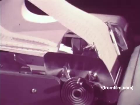 The still from 'IBM: Once Upon A Punched Card' (1964) showcases a close-up of a punch card machine in action. The machine processes punched cards, with the output paper visibly emerging from the device. This moment encapsulates the era's computing technology, highlighting the historical significance of punch cards in data processing. The image serves as a visual reminder of the transition from mechanical to electronic computing.   Follow us on Twitter @FromFilm.