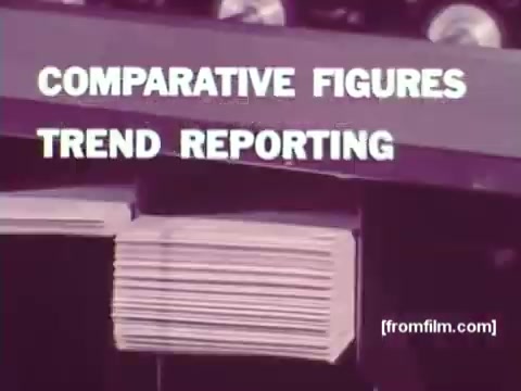 The still from 'IBM: Once Upon A Punched Card' (1964) features text that reads 'COMPARATIVE FIGURES' and 'TREND REPORTING.' The background suggests an industrial or computing environment, likely emphasizing the role of punch cards in data management and reporting processes of the time. This 16mm print captures the vintage aesthetics of the era, underscoring the historical significance of punch cards in computing history.