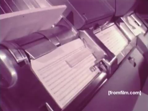 The still from 'IBM: Once Upon A Punched Card (1964)' showcases a close-up of early computing machinery, focused on punch card readers. The film likely highlights the evolution and significance of punch cards in data processing and computing history. The 16mm print captures the mechanical intricacies of the devices, emphasizing their role in automating information handling during the 1960s. Follow us on Twitter @FromFilm for more vintage computing insights!