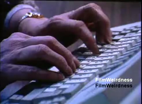 The still features a close-up of hands typing on a keyboard, reflecting the 1980s technology era. The keyboard appears dated, likely specific to the IBM System 36. The focus is on the movement of the hands, emphasizing interaction with early computer technology in a sales context. The overall tone suggests a demonstration of productivity and innovation.