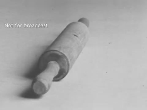 The still features a wooden rolling pin resting on a plain surface. The image is presented in grayscale, giving it a classic, vintage feel. The text 'Not for broadcast' appears at the top, indicating it is likely a behind-the-scenes or promotional piece related to the General Mills Total cereal commercial. The simplicity of the rolling pin may suggest themes of traditional cooking or home-made meals, linking to the idea of wholesome ingredients associated with the cereal.