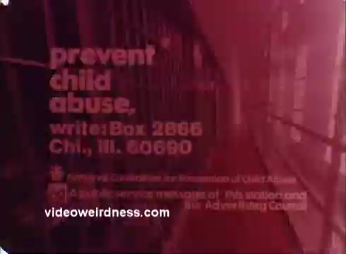 The still from the 'Prevent Child Abuse PSA - 1970s' features text urging viewers to prevent child abuse, with a clear call to action to write to a specific address in Chicago. The background likely includes a grim prison-like setting, underscoring the serious message about the long-term effects of child abuse. The voiceover stresses the connection between childhood abuse and future criminal behavior, framing child abuse as a significant national issue. The overall tone is stark and urgent, aimed at raising awareness and prompting societal change.
