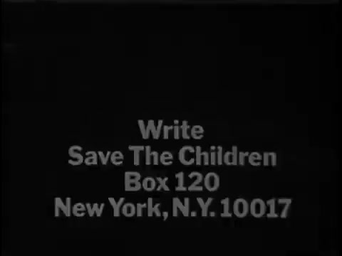The still features simple white text against a black background. It reads, 'Write Save The Children, Box 120, New York, N.Y. 10017.' This still is part of a 1967 commercial aimed at promoting the Save the Children organization, encouraging viewers to contribute or get involved.