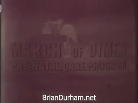 The still features text promoting the March of Dimes Prenatal Care Program from a 1968 PSA. It emphasizes the importance of proper prenatal care for expecting mothers, urging partners to ensure that their wives receive continuous medical attention and follow professional advice for the health of their baby. The visuals likely include icons associated with childbirth, such as a stork, symbolizing new life.