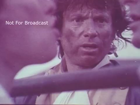 The still from the 'Molly Pitcher Bicentennial Savings Bonds PSA' features a close-up of a man with a distressed expression, suggesting a moment of tension or conflict. He appears disheveled and dirty, evoking a historical setting. The image captures a sense of urgency, likely related to the themes of sacrifice and patriotism tied to the concept of savings bonds during the bicentennial celebration.