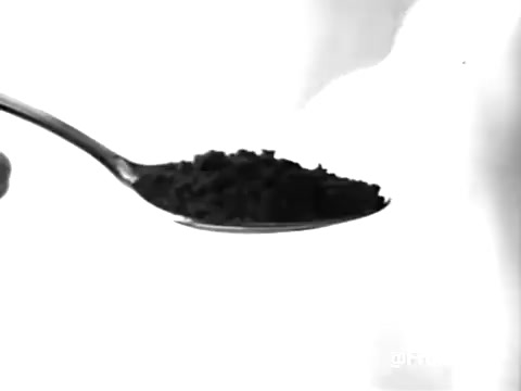 This still from the Sanka Coffee commercial features a close-up shot of a spoonful of coffee grounds against a stark, white background. The image has been converted to black and white, likely to emphasize the texture and contrast of the coffee. The 1960s aesthetic is present, and the commercial captures a nostalgic vibe associated with that era. It raises a playful question about the meaning of 'Sanka,' potentially hinting at a humorous undertone. Overall, the still serves as a snapshot of vintage advertising.   Feel free to subscribe, like, or follow for more!