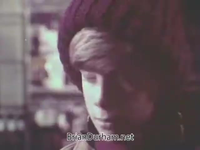 The still from the 1968 'Christmas Seal PSA' features a young boy wearing a knitted beanie, looking down with a solemn expression. The background suggests a holiday setting, likely conveying a message about the importance of supporting Christmas Seals, which raise awareness for health issues like tuberculosis. The overall tone is reflective, aiming to evoke empathy and encourage charitable giving.
