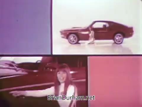 The still from the 1968 Ford Mustang commercial features a split-screen design, showcasing a bright, colorful background. Arte Johnson, using his Laugh-In character, is likely portrayed engaging humorously with the car. In the foreground, a woman points confidently toward the vehicle, which is prominently displayed. This commercial promotes the Ford Pop-Option sale, targeting viewers with catchy visuals and comedic elements aimed at making the Mustang appealing to potential buyers, set to air on WTRF in Wheeling, West Virginia.
