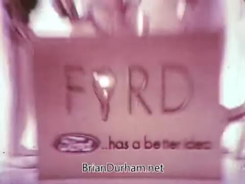 The still from the 1968 Ford Mustang commercial features a playful presentation by Arte Johnson, reminiscent of his character from 'Laugh-In.' The visual focuses on a sign that reads 'FORD' with a playful twist, promoting the Ford Pop-Option sale. The commercial's lighthearted tone aims to engage viewers, particularly for its airing on WTRF in Wheeling, West Virginia. The tagline, 'Ford... has a better idea,' emphasizes the brand's innovative appeal.