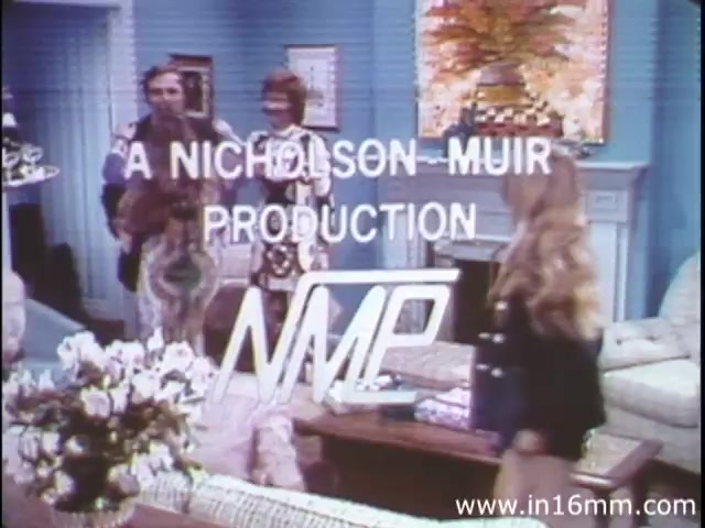 The still features a living room scene with characters interacting in a casual setting, likely preparing to address a topic related to health or digestion. The production is credited as 'A Nicholson-Muir Production' and is part of a 1980s version of 'I am Joe's Stomach.' The film employs a combination of three-dimensional animation and live-action to illustrate the human stomach's functions and care, particularly focusing on issues related to digestion and bodily functions. The overall tone appears educational and informative, aimed at enlightening viewers about gastrointestinal health through engaging visuals and narratives.