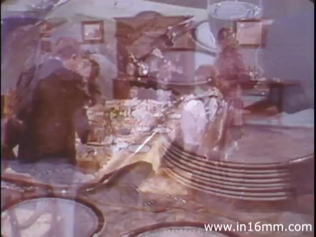 The still from 'I Am Joe's Stomach' features a lively dinner scene, blending live-action with animation. It captures the essence of a gathering, emphasizing the social aspects of eating. With a focus on food and interactions at the table, it highlights the relationship between consumption, digestive health, and the humorous consequences that can arise, connecting to the central theme of caring for one's stomach. The animation likely complements this narrative, illustrating the physiological processes within a figurative character experiencing digestive issues.