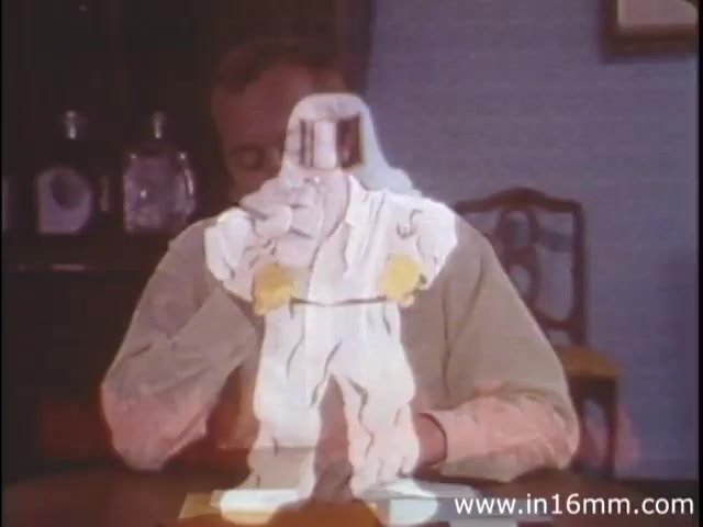 The still from 'I am Joe's Stomach' features a mix of live-action and animation, typical of the 1980s style. In the foreground, a character appears to be animated in a cartoonish style, depicted in a humorous manner, possibly portraying a stomach in distress. The background shows a man sitting at a table, seemingly engaged with the animated figure, emphasizing the film’s educational aspect regarding the functions of the human stomach. The animation reinforces the narrative of personal care and digestive health using engaging visuals to convey the importance of proper stomach care.