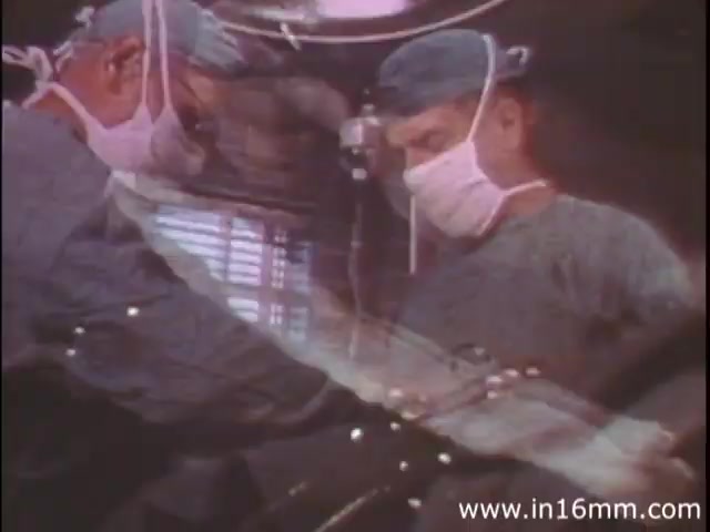 The still from 'I Am Joe's Stomach' showcases surgeons in a medical setting, dressed in scrubs and masks. The image captures the intricate process of surgery, likely representing the exploration or treatment of stomach-related health issues. The film uses a mix of animation and live-action to illustrate the human stomach's functions and to highlight the importance of proper care, emphasizing the character of Joe and his struggles with digestive problems. The visual style reflects the educational focus of the 1980s, aimed at informing viewers about bodily health in an engaging manner.
