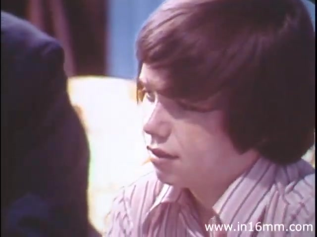 The still from 'I Am Joe's Stomach' features a young man with a thoughtful expression, wearing a striped shirt, suggesting a casual setting. The scene presumably explores the personal experiences related to digestive health, fitting the film's theme of depicting the functions of the human stomach through a blend of live-action and animation. This educational approach aims to convey the importance of stomach care and address issues related to digestion in an engaging manner.