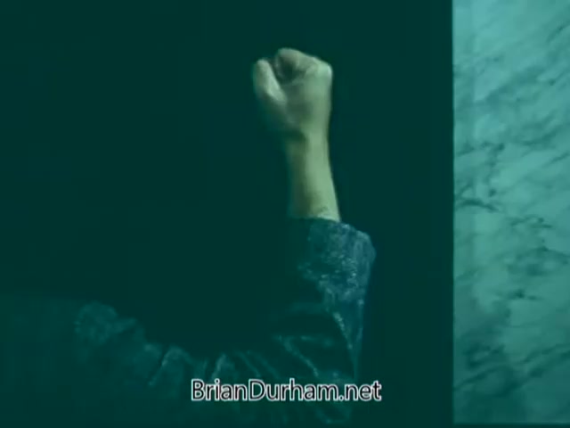 The still from the 'Point Park College PSA' features a close-up of a clenched fist, emphasizing a sense of determination or urgency. The background is dimly lit, contributing to a mood of intensity, while the arm appears partially illuminated, suggesting focus on the action of knocking or confronting. The overall composition creates a strong visual impact, conveying themes of empowerment or advocacy.