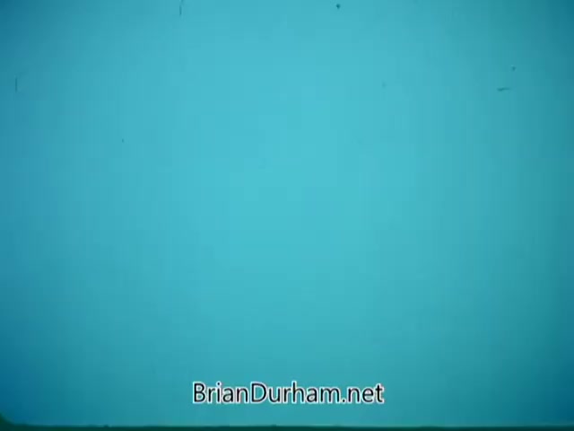 The still from 'Point Park College PSA' features a plain, solid blue background with some visible scratches or imperfections, indicating wear or age typical of 16mm film. There are no discernible images or text, making it a minimalistic frame that likely serves as a transition or title slide.