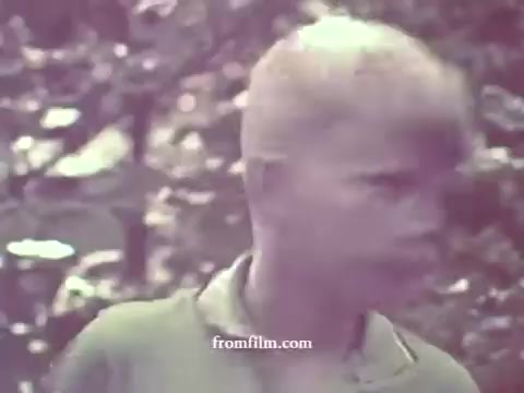 The image captures a boy with light blonde hair in a faded color palette, typical of a 1967 public service announcement regarding pesticides. The background features blurred greenery, suggesting an outdoor setting, possibly conveying a message related to the environment or safety. The overall quality is soft, reflecting the age of the 16mm print.