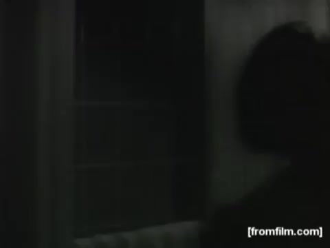 The still from the 1961 Zest soap commercial features a dimly lit scene, likely depicting a person in a bathroom setting. The focus appears to be on the act of washing or using the soap, emphasizing the product's refreshing qualities. The lighting and composition suggest a nostalgic atmosphere typical of early television commercials.