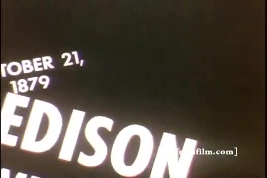 The still features text on a black background, reading 'OCTOBER 21, 1879' followed by 'EDISON.' This likely indicates a significant date related to Thomas Edison, possibly marking an important event in his career, such as the invention of the light bulb. The style suggests a historic commentary or educational focus typical of mid-20th century film.