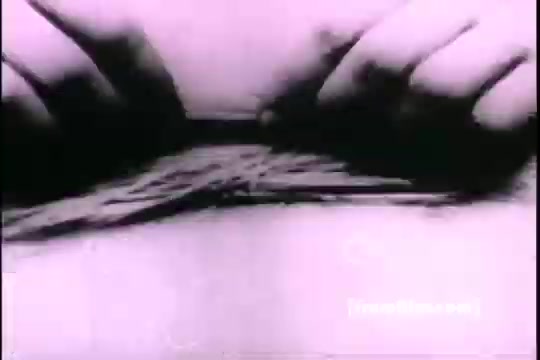 The still from 'Great Moments in History - Thomas Edison - Army Recruiting' shows a close-up of two hands manipulating a bundle of thin, flexible materials, possibly wires or strings. The image is monochromatic, typical of early 16mm film, with a focus on the intricate motion of the hands as they engage with the materials. The context suggests a demonstration or instructional scene related to Edison's innovations or contributions.