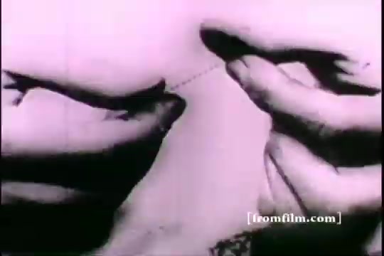 The still from 'Great Moments in History - Thomas Edison - Army Recruiting' shows a close-up of hands holding a thin wire or thread, possibly illustrating a moment of invention or experimentation. The image is in black and white, typical of 16mm prints, with a focus on the dexterity involved in handling the material, conveying a sense of precision and ingenuity.