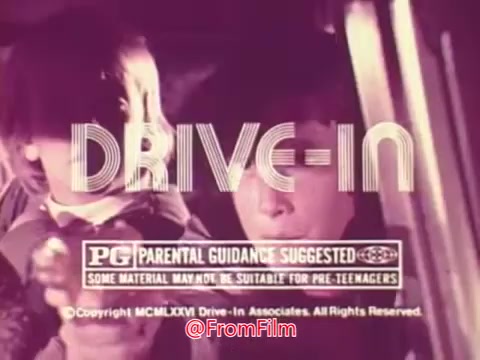 The still features the title 'DRIVE-IN' prominently, along with a 'PG' rating and a disclaimer stating that some material may not be suitable for pre-teens. The image likely captures a nostalgic vibe associated with drive-in theaters, with characters seen inside a car, suggesting a youthful or adventurous theme typical of 1970s cinema. The color tone appears warm, enhancing the retro feel of the trailer.