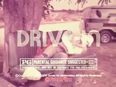 The still from the 1976 movie trailer for 'Drive-In' features a whimsical and colorful scene. The title 'DRIVE-IN' is prominently displayed at the top, with the 'PG' rating and parental guidance warning underneath. The background showcases a vintage outdoor setting, likely outside a drive-in theater, featuring trees and vehicles. The overall aesthetic captures the playful nostalgia of the era, hinting at themes of youthful adventure and outdoor entertainment.
