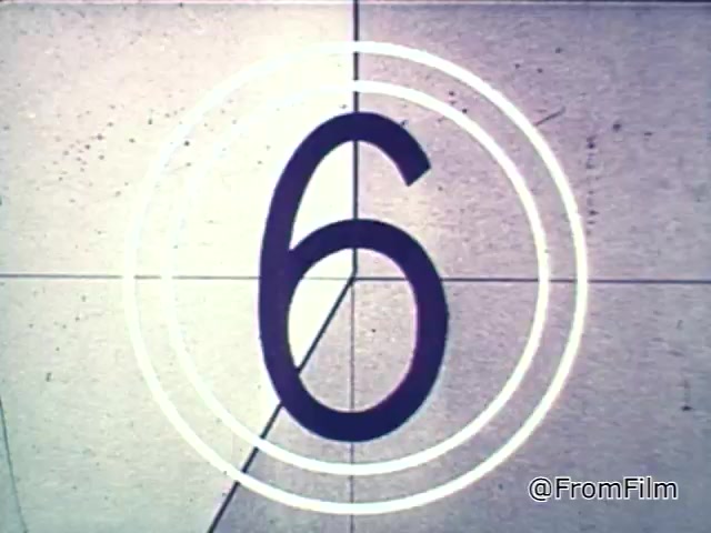 The 16mm still showcases a countdown typical of vintage film, with a large '6' inside concentric circles. This visual element is reminiscent of the 1960s, signaling the start of a commercial. In the context of the Chef Boyardee spaghetti sauce ad, it sets the stage for the voiceover discussing the quality of ingredients in spaghetti sauce, emphasizing visual appeal and richness as key factors in choosing Chef Boyardee.