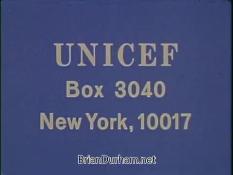 The still features a solid blue background with the word 'UNICEF' prominently displayed at the top in bold, golden letters. Below it, the address 'Box 3040, New York, 10017' is presented in a smaller, similarly styled font. This image is likely part of a public service announcement aimed at encouraging support for UNICEF, emphasizing the organization's mission to aid children in need.
